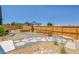 Landscaped backyard with stone walkways and raised garden beds, enclosed by a wood fence at 1148 Hillside Ln, Louisville, CO 80027