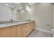 Bathroom with double vanity, modern lighting, and a tiled walk-in shower at 1148 Hillside Ln, Louisville, CO 80027