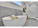 Modern bathroom features a soaking tub, stylish tile, and a glass-enclosed shower at 1148 Hillside Ln, Louisville, CO 80027