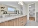 Bathroom featuring double sinks, modern lighting, stone countertop, and a walk-in closet at 1148 Hillside Ln, Louisville, CO 80027
