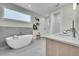 Modern bathroom featuring a soaking tub, walk-in shower, and marble countertops at 1148 Hillside Ln, Louisville, CO 80027