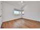 Bright, spacious bedroom featuring hardwood floors, large windows, and a ceiling fan at 1148 Hillside Ln, Louisville, CO 80027