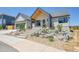 Beautiful, modern home with professional xeriscaping and inviting concrete stairway to a covered porch entry at 1148 Hillside Ln, Louisville, CO 80027