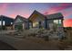 Gorgeous single-story home with a modern design, gray siding, stone accents, and professional landscaping at 1148 Hillside Ln, Louisville, CO 80027