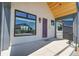 Inviting front porch with a modern aesthetic, featuring a purple front door and concrete landing at 1148 Hillside Ln, Louisville, CO 80027