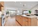 Spacious kitchen with sleek wooden cabinetry, a large island with seating, and an open dining area at 1148 Hillside Ln, Louisville, CO 80027