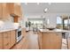 Open concept kitchen with wood cabinets, stainless steel appliances and adjacent dining area at 1148 Hillside Ln, Louisville, CO 80027