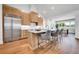Modern kitchen featuring a large island, stainless steel appliances, and beautiful wood cabinetry at 1148 Hillside Ln, Louisville, CO 80027
