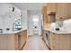 Bright kitchen features wood cabinets, stainless steel appliances, and modern light fixtures at 1148 Hillside Ln, Louisville, CO 80027