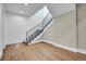 Bright living room featuring wood floors, staircase with iron railing, and ample natural light at 1148 Hillside Ln, Louisville, CO 80027