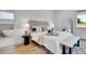 Beautifully decorated main bedroom featuring hardwood floors, lamps and neutral color palette at 1148 Hillside Ln, Louisville, CO 80027