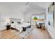 Bright main bedroom with vaulted ceiling, window and hardwood floors at 1148 Hillside Ln, Louisville, CO 80027