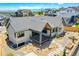 Stunning rear exterior featuring a covered patio, beautiful landscaping, and impeccable hardscaping at 1148 Hillside Ln, Louisville, CO 80027