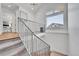 Modern staircase with metal railing leading to the upper level, natural light, and carpeted steps at 1148 Hillside Ln, Louisville, CO 80027