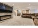 Finished basement boasting a stone fireplace, large sectional couch, and wet bar at 3120 Redhaven Way, Highlands Ranch, CO 80126