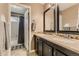 Tan bathroom featuring a double vanity with dark wood cabinets and a shower/tub combo at 3120 Redhaven Way, Highlands Ranch, CO 80126