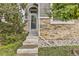 Charming home entrance featuring stone accents, stylish front door, and well-maintained landscaping at 3120 Redhaven Way, Highlands Ranch, CO 80126
