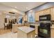 Modern kitchen featuring a center island, sleek appliances, and an adjacent dining area at 3120 Redhaven Way, Highlands Ranch, CO 80126