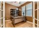 Bright office with a custom desk, built-in shelving, and hardwood floors at 3120 Redhaven Way, Highlands Ranch, CO 80126