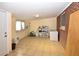 Finished basement with tiled floors, white brick accent wall, and storage shelf at 2211 Quebec St, Denver, CO 80207