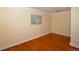 Bedroom with natural light, gleaming hardwood floors and neutral paint at 2211 Quebec St, Denver, CO 80207