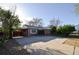 Charming brick home features a carport, well-maintained landscaping, and a spacious driveway at 2211 Quebec St, Denver, CO 80207