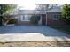Charming brick home features a carport and a spacious driveway at 2211 Quebec St, Denver, CO 80207