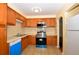 Kitchen featuring wood cabinets, stainless steel appliances and tile countertops at 2211 Quebec St, Denver, CO 80207