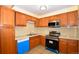 Kitchen featuring wood cabinets, stainless steel appliances and tile countertops at 2211 Quebec St, Denver, CO 80207