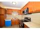 Kitchen featuring wood cabinets, stainless steel appliances and tile countertops at 2211 Quebec St, Denver, CO 80207
