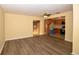 Living room opens to kitchen featuring wood floors, neutral walls, and ceiling fan at 2211 Quebec St, Denver, CO 80207