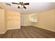 Living room featuring new wood floors, neutral yellow walls, and a ceiling fan at 2211 Quebec St, Denver, CO 80207