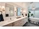 Modern bathroom with double vanity, soaking tub, and walk-in shower at 3153 Benton St, Wheat Ridge, CO 80214