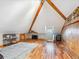 Finished attic space with exposed wood beams, hardwood floors, and a rustic aesthetic at 5801 W 33Rd Ave, Wheat Ridge, CO 80212