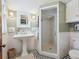 Bright bathroom featuring a pedestal sink, glass-enclosed shower, and classic tile at 5801 W 33Rd Ave, Wheat Ridge, CO 80212