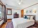 Light-filled bedroom features hardwood floors, ceiling fan, decorative rug and views of exterior greenery at 5801 W 33Rd Ave, Wheat Ridge, CO 80212