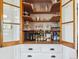 Charming built-in shelving with glass door fronts and lower drawers for storage at 5801 W 33Rd Ave, Wheat Ridge, CO 80212