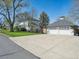 Traditional two-story home with well-maintained landscaping and a detached garage with carriage doors at 5801 W 33Rd Ave, Wheat Ridge, CO 80212