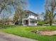 Charming two-story home with inviting front porch, manicured lawn, and beautiful landscaping creates a warm and welcoming atmosphere at 5801 W 33Rd Ave, Wheat Ridge, CO 80212