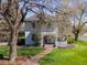 Charming two-story home with inviting front porch, manicured lawn, and beautiful landscaping creates a warm and welcoming atmosphere at 5801 W 33Rd Ave, Wheat Ridge, CO 80212