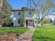Quaint two-story home with a red front door and inviting covered porch at 5801 W 33Rd Ave, Wheat Ridge, CO 80212