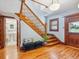 Elegant foyer with wood staircase, hardwood floors, and stylish decor at 5801 W 33Rd Ave, Wheat Ridge, CO 80212