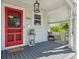 Welcoming front porch with stylish seating and a vibrant red front door at 5801 W 33Rd Ave, Wheat Ridge, CO 80212