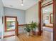 Second floor hallway features wood floors, natural light, and view to the bonus room at 5801 W 33Rd Ave, Wheat Ridge, CO 80212