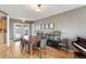 Dining room with a large wooden table, chairs, shelving, and access to the kitchen and outdoor area at 350 Kohl St, Broomfield, CO 80020