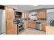 Beautiful kitchen featuring stainless steel appliances, wooden cabinets, and granite countertops at 350 Kohl St, Broomfield, CO 80020