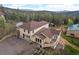 Aerial view of a home nestled in a wooded area, showcasing the home's backyard and surrounding scenery at 27987 Pine Grove Trl, Conifer, CO 80433