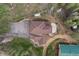 Bird's-eye view of a house with a deck, patio, and circular driveway at 27987 Pine Grove Trl, Conifer, CO 80433