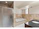 Luxurious bathroom with a shower, soaking tub, marble tile, and granite vanity at 27987 Pine Grove Trl, Conifer, CO 80433