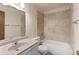 Bright bathroom featuring a tiled shower-over-bath and single sink vanity at 27987 Pine Grove Trl, Conifer, CO 80433